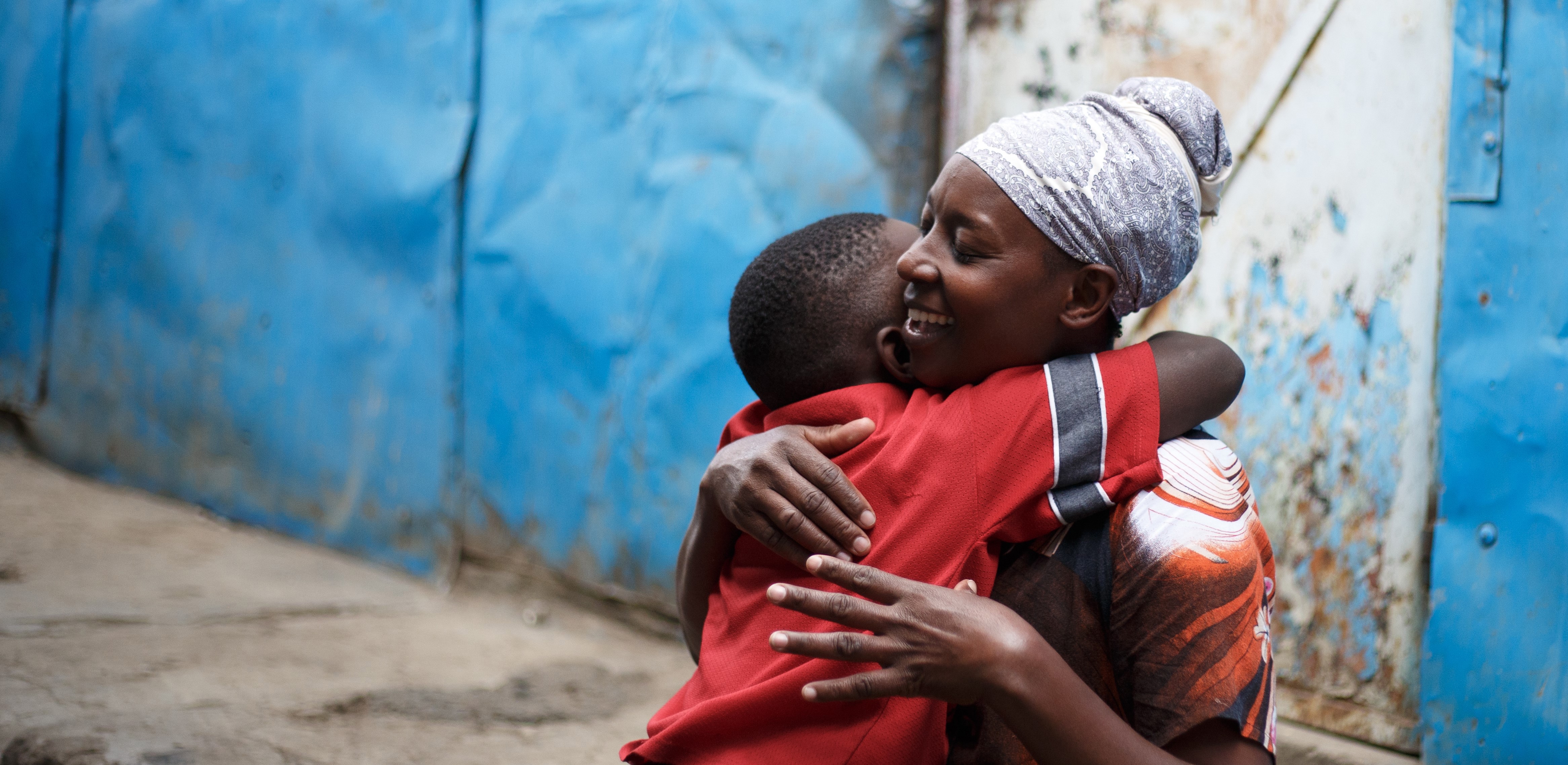 Kenya FS Nairobi 11 boy hugging mother joyful intimate moment bond, Sandra's Story, Jakob Fuhr.jpg